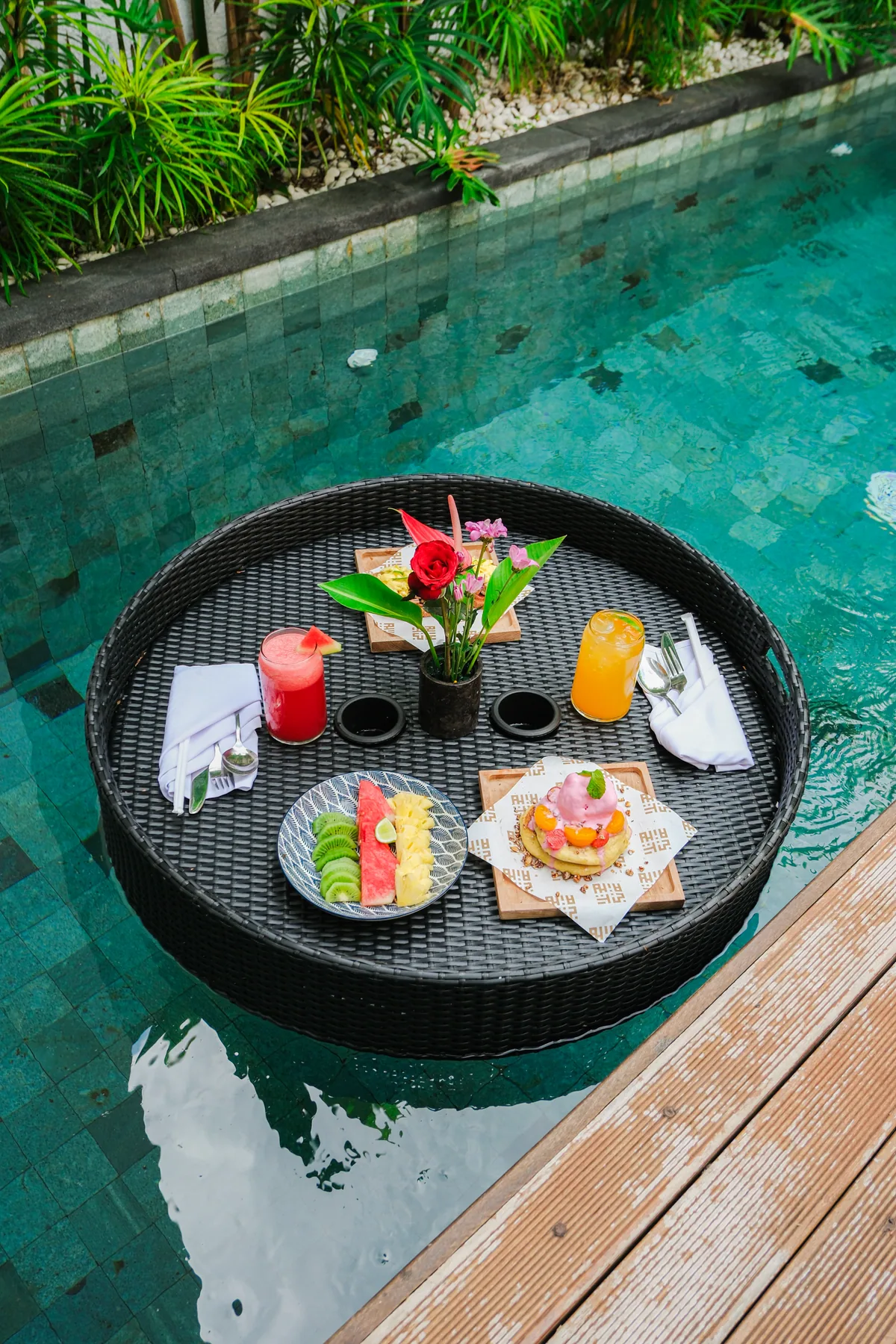 Breakfast tray with food and drinks set in the pool at Tannari Villas