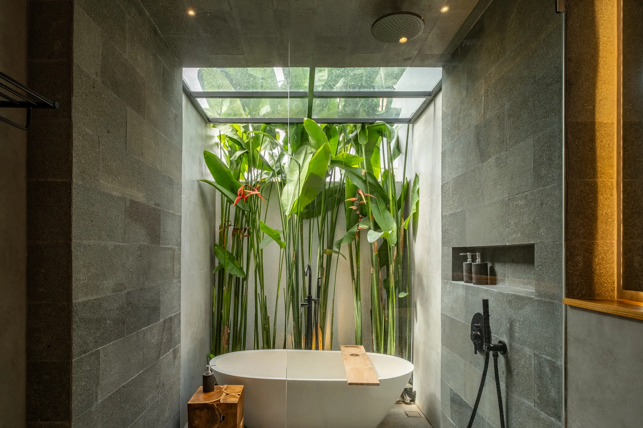 Mezzanine villa freestanding bathtub beneath a skylight